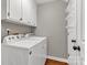 Laundry room with overhead cabinets, utility sink, and washer and dryer at 7214 Quail Meadow Ln, Charlotte, NC 28210