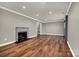 Bright living room features hardwood floors, fireplace, crown molding and recessed lighting at 7214 Quail Meadow Ln, Charlotte, NC 28210