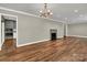 Open concept living room features hardwood floors, fireplace, and views into the kitchen at 7214 Quail Meadow Ln, Charlotte, NC 28210
