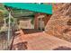 Covered patio with red tiles, brick home exterior, and garden views at 7214 Quail Meadow Ln, Charlotte, NC 28210