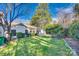 Large backyard features lush green grass, mature trees, and trimmed hedges at 7532 Red Oak Ln, Charlotte, NC 28226
