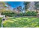 Large, green backyard with a manicured lawn and mature trees providing shade and privacy at 7532 Red Oak Ln, Charlotte, NC 28226
