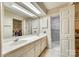 Bright bathroom featuring a dual sink vanity, ample storage, and a separate shower room at 7532 Red Oak Ln, Charlotte, NC 28226
