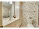 This bathroom features wallpaper, a built-in vanity with drawers, and a toilet at 7532 Red Oak Ln, Charlotte, NC 28226