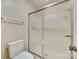 Clean bathroom features a shower with frosted sliding glass doors and a low-flow toilet at 7532 Red Oak Ln, Charlotte, NC 28226