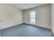 This bedroom features a single window for natural light and carpeted flooring at 7532 Red Oak Ln, Charlotte, NC 28226