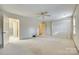 Bright and airy bedroom with carpet flooring, ceiling fan, and access to an ensuite bathroom at 7532 Red Oak Ln, Charlotte, NC 28226