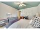This bedroom features a calming color scheme, ceiling fan, and a streamlined work area at 7532 Red Oak Ln, Charlotte, NC 28226