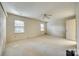 Spacious bedroom with neutral carpet, ceiling fan, and natural light from multiple windows at 7532 Red Oak Ln, Charlotte, NC 28226
