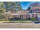 Charming brick home with well-maintained landscaping, shutters, and inviting front entrance at 7532 Red Oak Ln, Charlotte, NC 28226