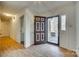 Bright entryway with updated flooring, featuring a unique front door and sidelight panels at 7532 Red Oak Ln, Charlotte, NC 28226