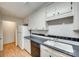 Efficient kitchen featuring white cabinets, black appliances, and updated countertops at 7532 Red Oak Ln, Charlotte, NC 28226