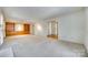 Large living room with built-in shelving, neutral carpet, and ample natural light at 7532 Red Oak Ln, Charlotte, NC 28226