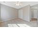 Neutral bedroom features ceiling fan and double door closet, providing ample storage space at 8430 Forest Shadow Cir, Cornelius, NC 28031