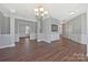 Elegant dining area with stylish chandelier and dark wood floors, ideal for Gathering gatherings at 8430 Forest Shadow Cir, Cornelius, NC 28031