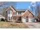 Charming two-story home featuring a brick facade, a two-car garage, and a well-manicured lawn at 8430 Forest Shadow Cir, Cornelius, NC 28031