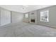 Large living room featuring carpet, a fireplace, and lots of natural light at 8430 Forest Shadow Cir, Cornelius, NC 28031