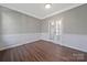 Cozy office space with French doors, chair railing, and modern dark wood flooring at 8430 Forest Shadow Cir, Cornelius, NC 28031