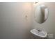 Neat half bathroom with a sink, mirror, and white paint at 920 Lakehill Rd, Charlotte, NC 28214