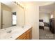 Bright bathroom features double sinks with a large mirror and a doorway to the bedroom at 920 Lakehill Rd, Charlotte, NC 28214