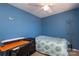 Comfortable blue bedroom with a desk and bed, great for a workspace and relaxation at 920 Lakehill Rd, Charlotte, NC 28214