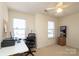 Bright bedroom with a ceiling fan, natural light, and a computer desk with a rolling chair at 920 Lakehill Rd, Charlotte, NC 28214