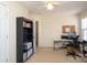 Functional bedroom with a desk, shelving and a ceiling fan to create a comfortable workspace at 920 Lakehill Rd, Charlotte, NC 28214