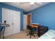 Blue bedroom offering a dedicated workspace, wardrobe, and access to natural light at 920 Lakehill Rd, Charlotte, NC 28214