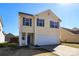 Charming two-story home boasts a well-manicured lawn, a garage, and inviting curb appeal at 920 Lakehill Rd, Charlotte, NC 28214
