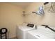 Well-lit laundry room is equipped with modern washer and dryer units for convenience at 920 Lakehill Rd, Charlotte, NC 28214