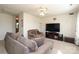 Cozy living room with plush sofas, ceiling fan, and large TV at 920 Lakehill Rd, Charlotte, NC 28214