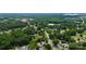 This aerial view highlights the location of the house surrounded by trees, along with an arrow to the property at 9808 Washam Potts Rd, Cornelius, NC 28031