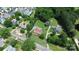 This aerial view showcases a home surrounded by lush greenery, other residences, and a road at 9808 Washam Potts Rd, Cornelius, NC 28031