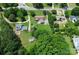 Aerial view showcases several houses with large yards, driveways, sheds, and lots of surrounding greenery at 9808 Washam Potts Rd, Cornelius, NC 28031