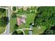 Aerial view showcasing a home, large yard, a driveway, sheds and lots of surrounding greenery at 9808 Washam Potts Rd, Cornelius, NC 28031