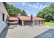 Back deck features an umbrella, hammock, and lush, mature trees for privacy and shade at 9808 Washam Potts Rd, Cornelius, NC 28031