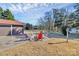 Backyard with a firepit and several Adirondack chairs on a paved patio next to a small building at 9808 Washam Potts Rd, Cornelius, NC 28031