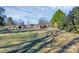Spacious lot with a basketball hoop, detached garage and a large grassy area perfect for recreation at 9808 Washam Potts Rd, Cornelius, NC 28031