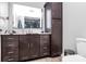 Modern bathroom features a large mirror, wood cabinets, and sleek fixtures offering comfort and style at 9808 Washam Potts Rd, Cornelius, NC 28031