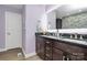 Bathroom featuring a double vanity with dark wood cabinets and modern fixtures at 9808 Washam Potts Rd, Cornelius, NC 28031