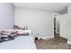 Cozy bedroom features comfortable bedding and hardwood floors, perfect for relaxation and rest at 9808 Washam Potts Rd, Cornelius, NC 28031