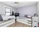 Bedroom featuring two beds with storage drawers underneath, a ceiling fan, and neutral decor at 9808 Washam Potts Rd, Cornelius, NC 28031