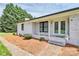 Charming brick home featuring a covered front porch and manicured landscaping at 9808 Washam Potts Rd, Cornelius, NC 28031