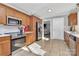 Modern kitchen with stainless steel appliances, wooden cabinets, ceramic tile flooring, and great natural light at 9808 Washam Potts Rd, Cornelius, NC 28031