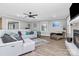 Stylish living room boasts modern furniture, a ceiling fan, and wood-look flooring at 9808 Washam Potts Rd, Cornelius, NC 28031