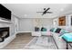 Comfortable living room with a white brick fireplace, ceiling fan, and plush sectional sofa at 9808 Washam Potts Rd, Cornelius, NC 28031