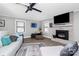 Beautiful living room with white brick fireplace, ceiling fan, and plenty of seating at 9808 Washam Potts Rd, Cornelius, NC 28031