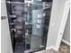 Modern shower with a glass door, sleek fixtures, and a black pebble floor at 9808 Washam Potts Rd, Cornelius, NC 28031