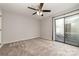 Bedroom with neutral carpet, fan and sliding glass door to balcony at 100 Willow Run Dr # 7, Gastonia, NC 28056