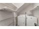 Compact laundry room with washer, dryer, and storage shelving at 100 Willow Run Dr # 7, Gastonia, NC 28056